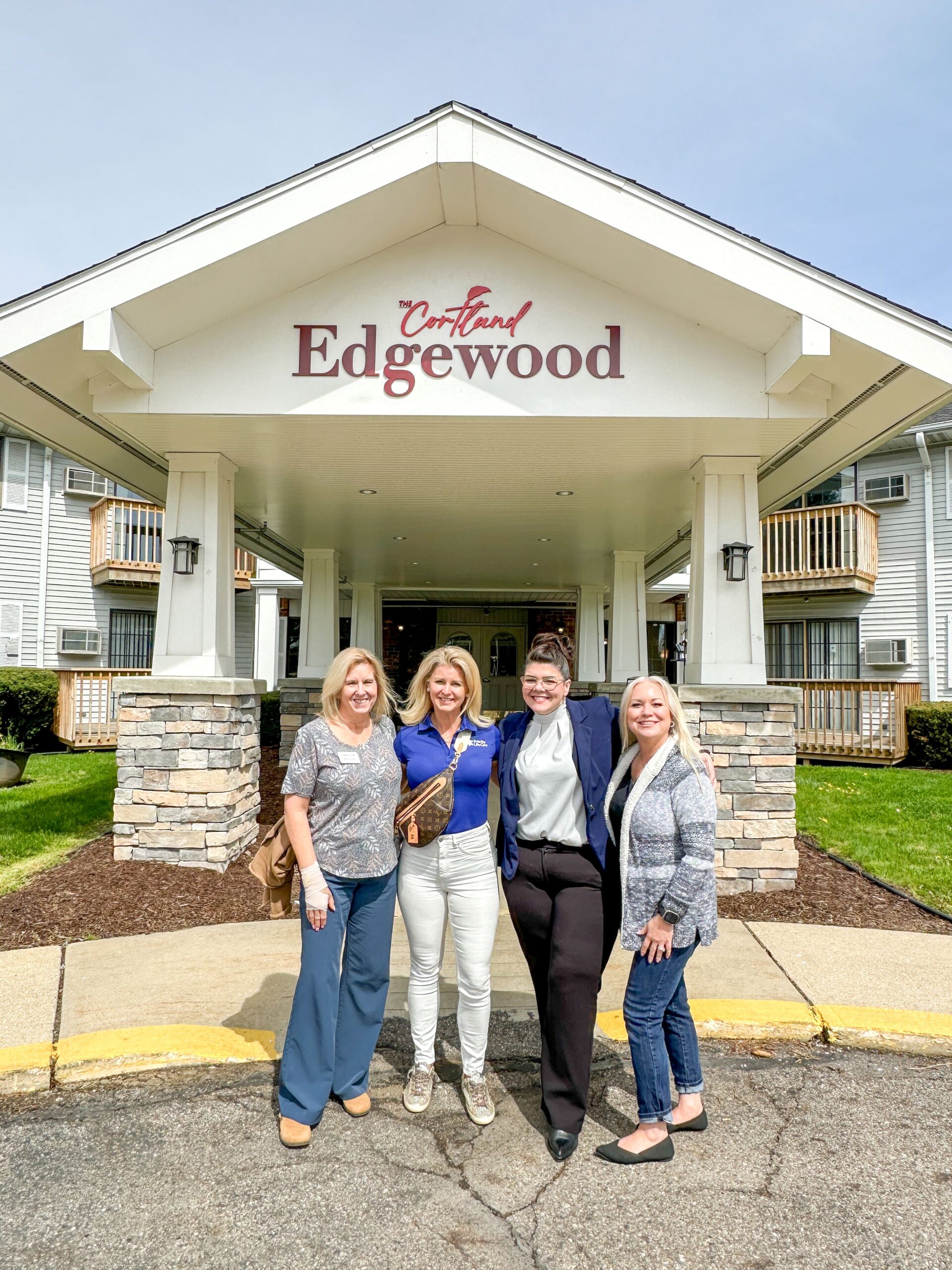 Group photo of four women in front of the Cortland Edgewood entrance